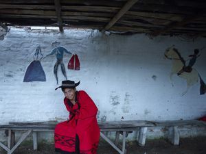 Devotee child dressed up with the local costume featruing the saint red colour, in Saladas village