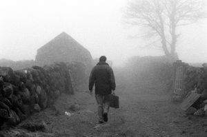 Dr Arthur Mitchell, GP,visiting one of his more remote families living on the mountains of Mourne, 1998