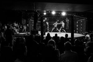 The Italian mixed martial athlete Giorgio Pietrini fights against the Spanish Eulogio Fernandez. In Italy, MMA matches last for 5 rounds and they take place in a caged MMA ring of around 50 m2. Every MMA round lasts maximum five minutes, followed by a one-minute rest period.