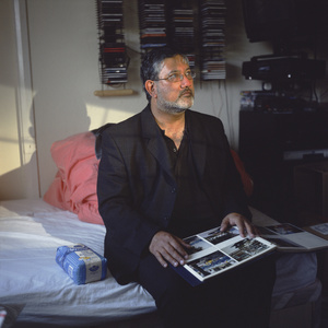 Ron Davies, 'Fun-powder Plotter', in his bed-sit with family album, a week after being arrested under the Terrorism Act. West Sussex UK, 26 May 2004,