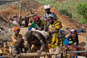 Exhausted young girls are waiting in burning heat at the entrance of a mine. It will be their fifth load of stones today. Each girl carries a load of approximately 25 kilos, a stretch of 2 kilometers and 300 meters descent to the temporary working village of Djuga. © Matjaz Krivic