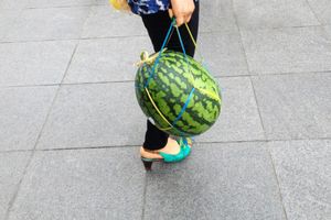 A lady with a watermelon.
