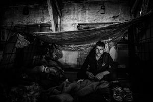View of the inside temporary "room" in a barrack in Serbia, Belgrade. During the rain the roof is leaking, so man made a roof from plastic. Belgrade, Serbia.