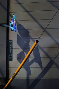 The shadow of a streetlight that disappears with the sunrise.