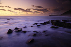 Silence  / A double long exposure on the Cape Peninsula with blurry water and rocks in the foreground and the sky at sunset with clouds and far away mountains in the background. Shut up ...