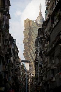 Rundown neighborhoods contrast with the glitzy Grand Lisboa hotel on Macau’s skyline
