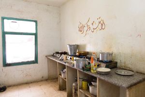 The communal kitchen in a half-finished building that houses Syrian families. The rent is high, almost unaffordable for many families in the building. Many large and extend families have to share a room. Some have to share with a family they've never known before fleeing Syria. The is no privacy, no respite for anyone. © David Brunetti