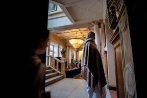 A devotee checks the bulletin board for transport options. Radhadesh is a rural retreat in the Ardennes and is relatively isolated