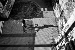A shadow and its bicycle rider in Vienna, Austria