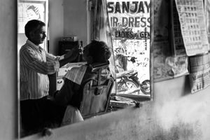 The Barber - I catch a reflection of Sanjay in the mirror on the rear wall.
