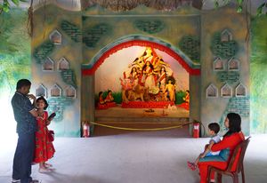 Parents taking their children for pandal hopping.
