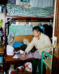 Woman sharing a cubicle flat with her son, Sham Shui Po