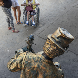 A mime-artist sits on the Plaza de la Catedral in old Havana.