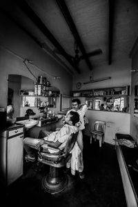 The Barber - Sanjay chats with a customer while lazily applying shaving cream in-between yawns