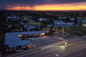 Rain Overtaking Sunset as Bike Passes Motel