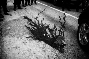 A pool of blood in the main highway of Caracas after a shooting between gang members and police officers, neighbors said police execute the gangster after they surrender.