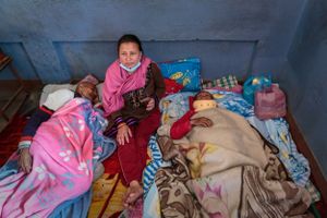 Inside a school, set up as a temporary refugee camp for internally displaced people, 72 year old Ram Shilpakar recovers from a broken ribs and head trauma sustained during the 2015 Nepal earthquake.