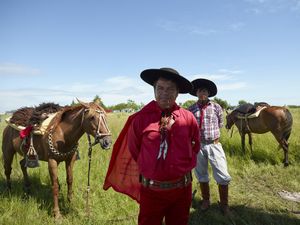 Gauchito Gil father and son devotees with their horses at the national gathering in Mercedes town for  the celebrations of January 8, date of the murder of the popular saint
