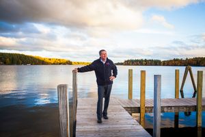 After inviting members of the media to join him and his staff on a brisk walk through Center Harbor, off the record and without their cameras, Republican presidential candidate Gov. John Kasich of Ohio concedes to a few photos on a dock overlooking Lake Winnipesaukee during a campaign bus tour through New Hampshire on Wednesday, Oct. 14, 2015.