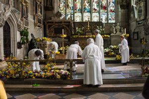 The clergy of Holy Trinity Church Stratford-upon-Avon orange flowers given by participants of the parade.
