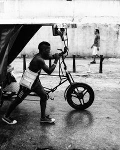 Hard going pushing a tricycle. Havana, Cuba