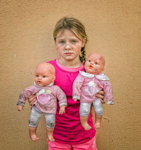 Irish Traveller girl with dolls