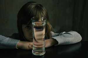 Portrait of a girl with a glass of water