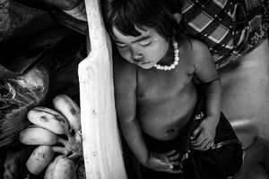 A child sleeps during the long journey from Batambang to Siem Reap . This may take at least 8 hr and sometimes cannot be completed when the water levels are low