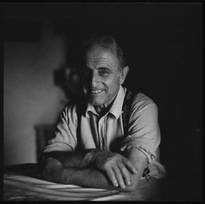 Farmer in the kitchen of his alp-hut, Varvalanna, Gruyère.