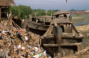 Disused fishing boats and piles of garbage, Cox's Bazar, Bangladesh