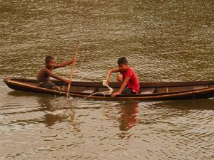 Boys bailing canoe, Limoeiro de. Ajuru Islands (River community in Limoeiro de Ajuru, Pará, Amazônia, Brazil)
