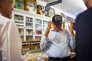 Republican presidential candidate Gov. John Kasich of Ohio decides a hat is too big while trying it on at Fadden's General Store in North Woodstock during a campaign bus tour through New Hampshire on Wednesday, Oct. 14, 2015.