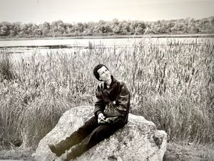 Carol seated on rock, birdwatching