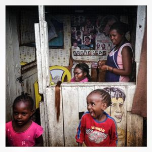 A woman has her hair done at a hairdressers in Kibera. The Kibera slum is the largest slum in Nairobi with around half a million inhabitants
