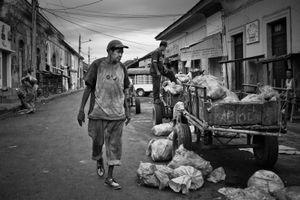At 6 AM,  this man's day of work has long begun. He is seen here, after having travelled the two hour long mule driven ride, from the regional slaughter house.Granada Market, Nicaragua, February 2014                           © Enilffo Raeppa