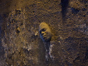 USA. Chicago. 2015.  Sculpture face coming out of a wall in a tunnel somewhere in Chicago.