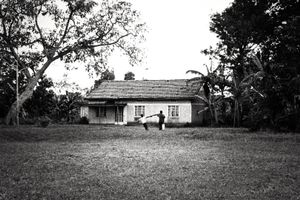 An old english colonial house. Now these building are used as common warehouse. In the picture two guys go to put a full water barrel into storage. In this community the water is truly a common good © Nicola Angelo Mangia