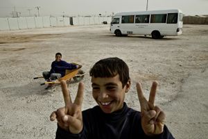 Two boys fooling around at the camp's main entrance. © Tom Verbruggen