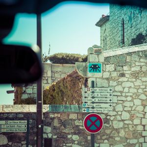Rearview mirror Space Invader and signs.