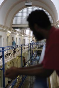 An inmate looks over the wing outside of his cell on the top balcony of the A wing at Wandsworth Prison. HMP Wandsworth in South West London was built in 1851 and is one of the largest prisons in Western Europe. It has a capacity of 1456 prisoners.