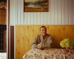Old man drinking beer in a small pub at Kalvariju market, Vilnius, Lithuania, September 2015.