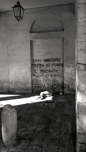 A homeless man sleeps under a covered walkway, 2011
