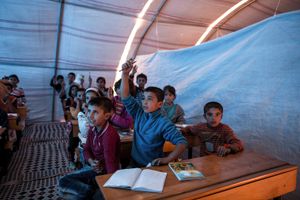 Kurdish children from Kobani take lesson in an improvised classroom in 'Kobani' refugee camp in the border town of Suruc, Sanliurfa province, Turkey on November 10, 2014.