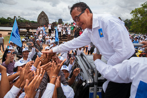 Opposition leader Sam Rainsy salutes supporters in front of Angkor Wat, Siem Reap.