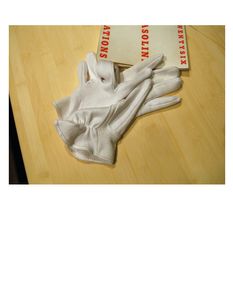 Plate 1:  Two gloves and Ed Ruscha's artist's book "TWENTYSIX GASOLINE STATIONS," 1963, photo 2006-LK.