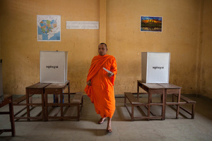 A Buddhist monk casts his vote at Wat Phnom Bunrang High School voting station in Phnom Penh.