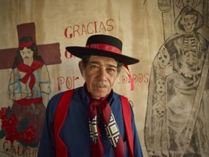 Chamamé dancer portrayed between the icons of Gauchito Gil and san la Muerte popular saints in El Campito de la Carolina temples