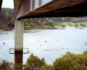 A couple climbing in the inside of Trijų mergelių tiltas bridge, Kaunas, Lithuania, September 2015.