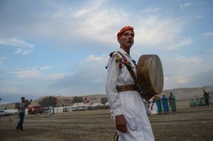 A Bendir musician and performer, part of the fantasia's traditional entertainment, watches on. Tissa, Morocco
