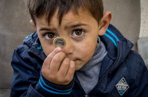 El Puche, Almeria, Spain. Child with coin.